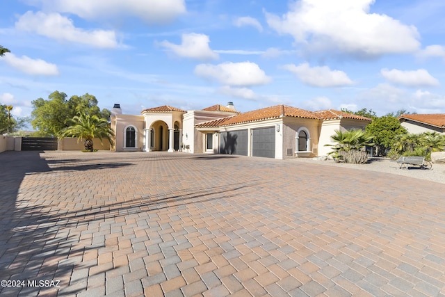 mediterranean / spanish-style house with a garage