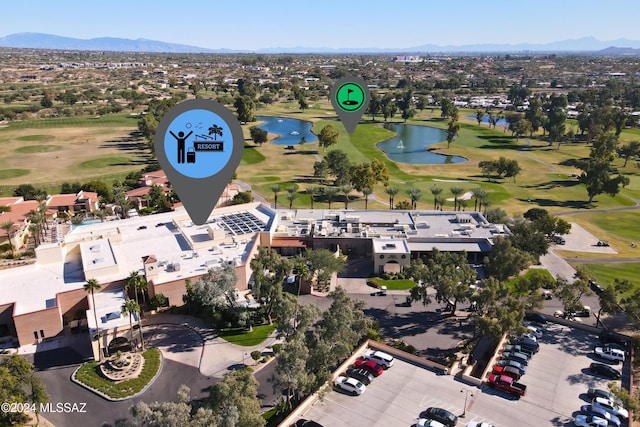 birds eye view of property with a water and mountain view