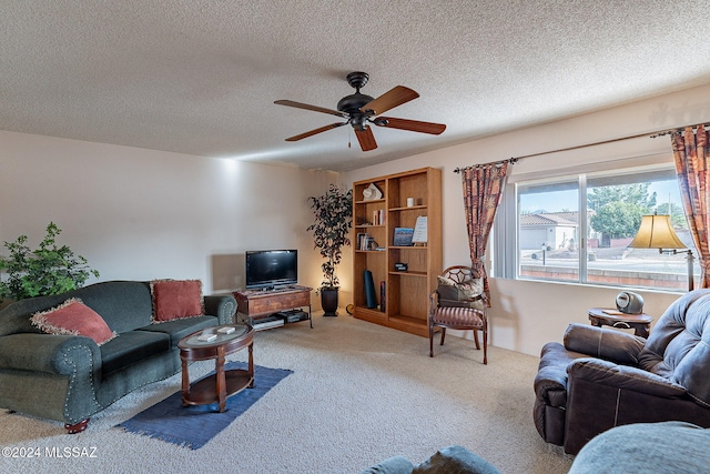 living room with ceiling fan, carpet, and a textured ceiling