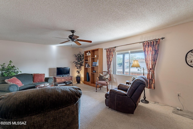 living room with a textured ceiling, ceiling fan, and carpet