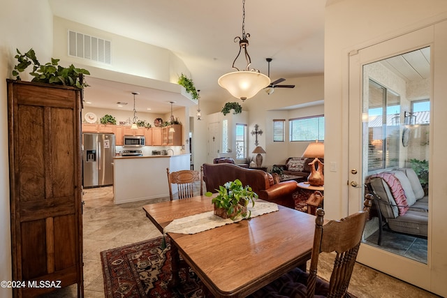 dining room with ceiling fan and vaulted ceiling