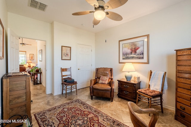 living area featuring ceiling fan