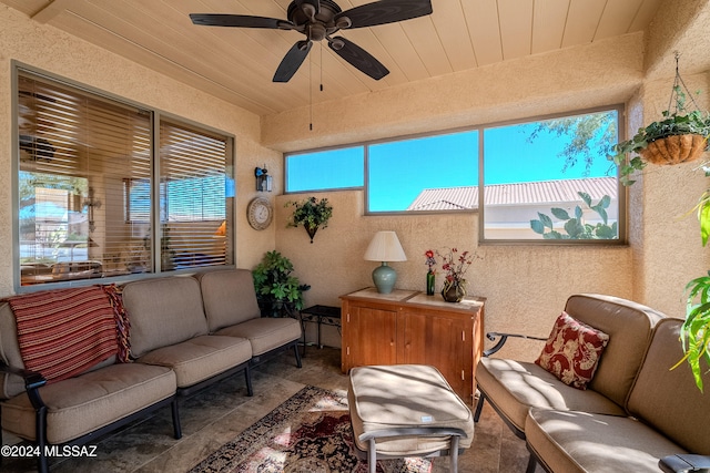 sunroom featuring ceiling fan and wood ceiling