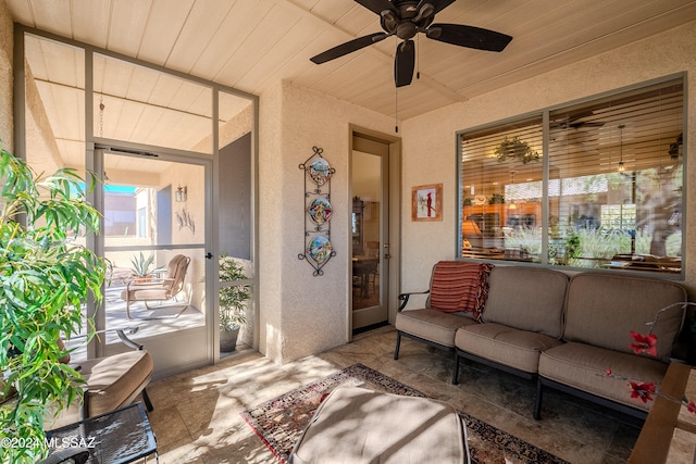 exterior space featuring ceiling fan, wooden ceiling, and a healthy amount of sunlight