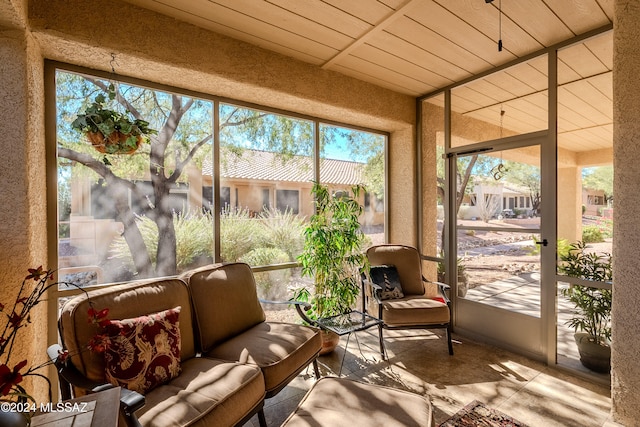 sunroom featuring a wealth of natural light and wooden ceiling