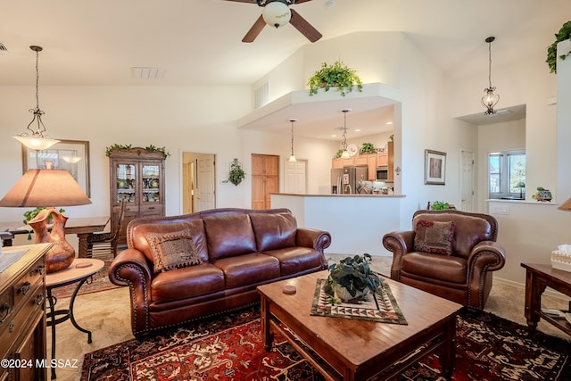 carpeted living room featuring high vaulted ceiling and ceiling fan