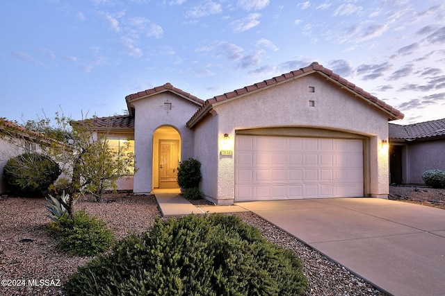 mediterranean / spanish-style home featuring a garage