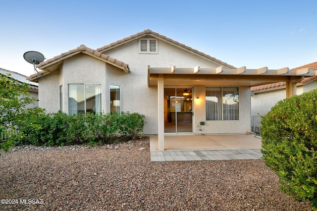 rear view of house featuring cooling unit and a patio