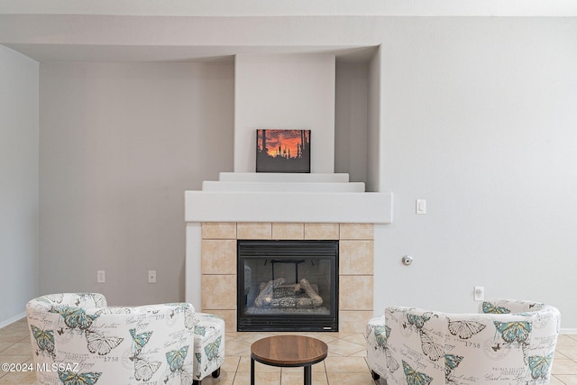 living area featuring a tile fireplace and light tile patterned flooring