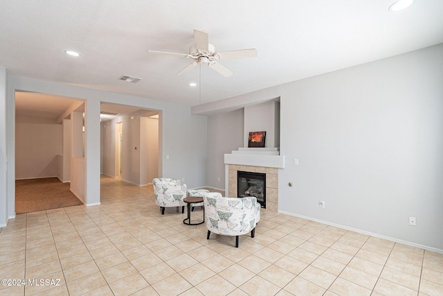 unfurnished room featuring recessed lighting, visible vents, light tile patterned flooring, ceiling fan, and a tile fireplace