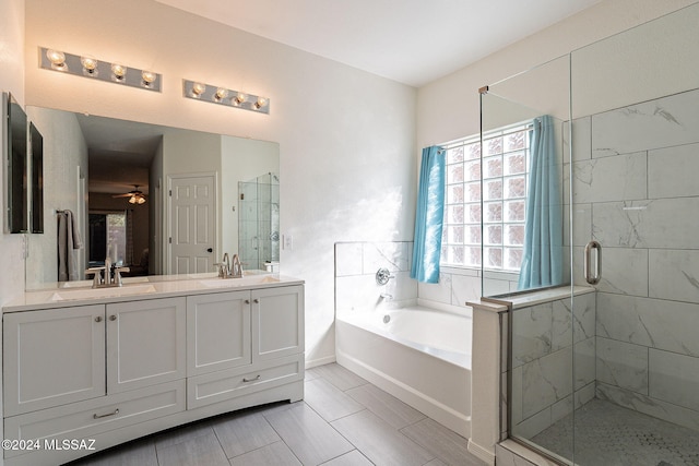 bathroom featuring double vanity, a sink, a shower stall, and a bath