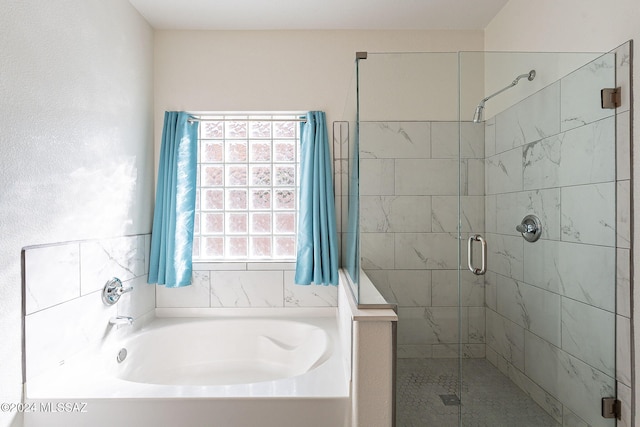 full bath featuring a garden tub and a shower stall