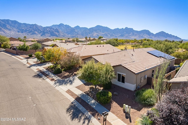 drone / aerial view featuring a residential view and a mountain view