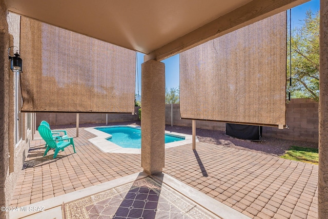 view of pool with a fenced in pool, a fenced backyard, and a patio