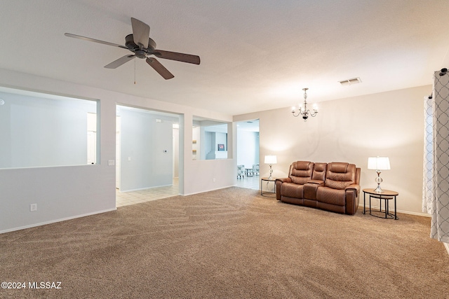 carpeted living area with visible vents, baseboards, and ceiling fan with notable chandelier