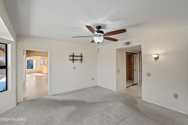 carpeted empty room with ceiling fan