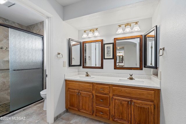 bathroom with an enclosed shower, vanity, and toilet