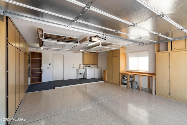 garage with washer and clothes dryer and sink