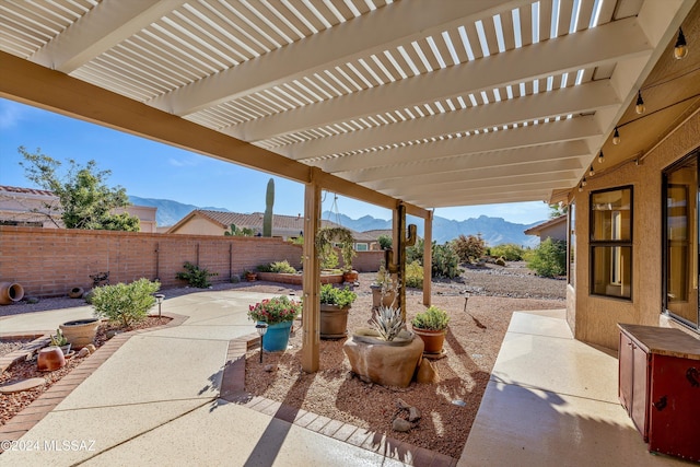 view of patio with a pergola and a mountain view