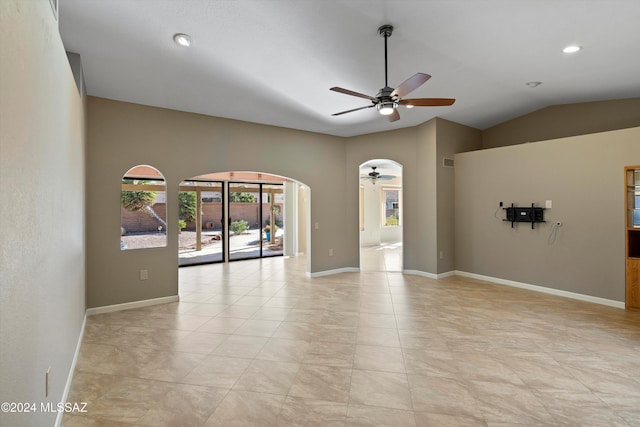 empty room featuring ceiling fan and vaulted ceiling