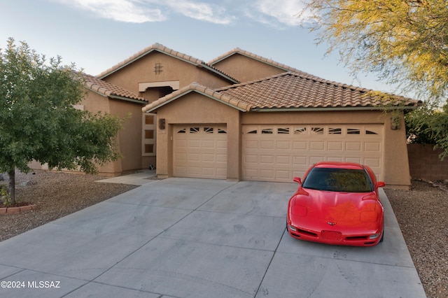 mediterranean / spanish house with a garage