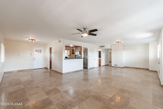 unfurnished living room with ceiling fan