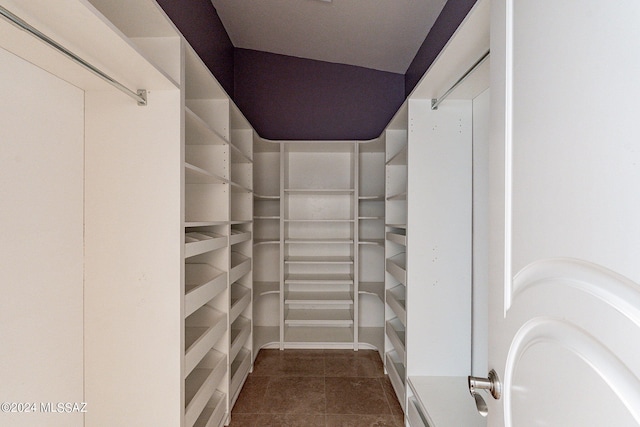 walk in closet featuring dark tile patterned flooring