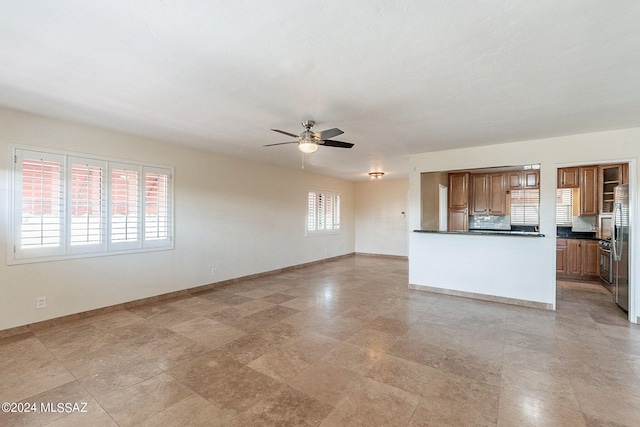 unfurnished living room featuring ceiling fan