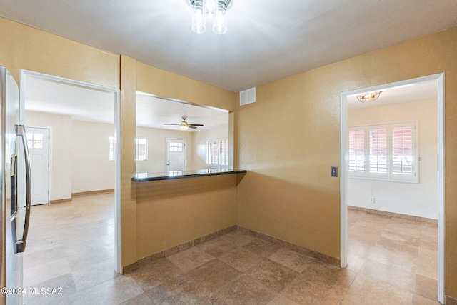 kitchen featuring ceiling fan and stainless steel fridge with ice dispenser