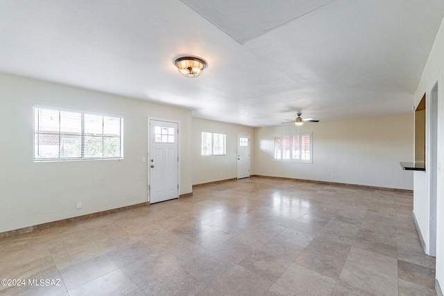 foyer featuring a healthy amount of sunlight and ceiling fan