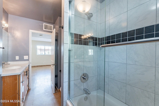 bathroom featuring vanity, tiled shower / bath combo, and tile patterned floors