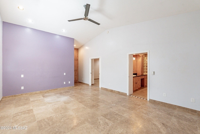 spare room featuring ceiling fan and high vaulted ceiling