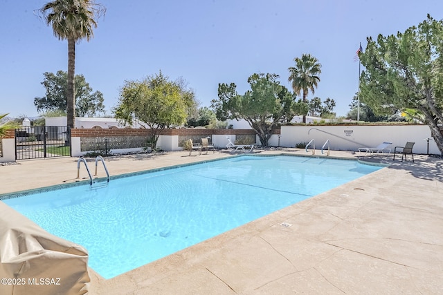 community pool featuring a patio area and fence