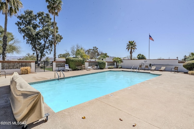 pool with fence and a patio