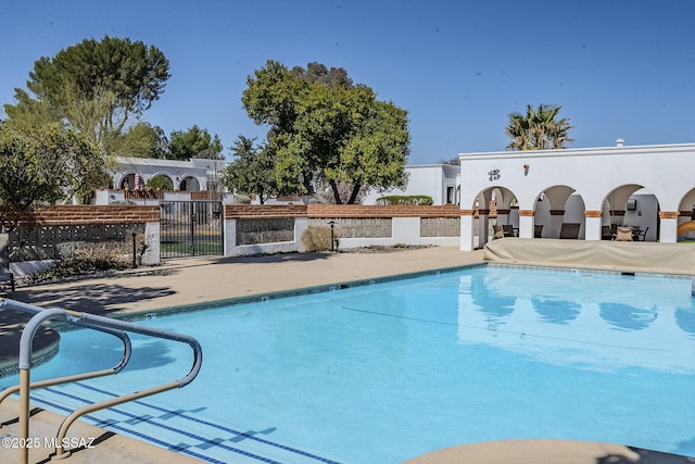 community pool with a gate and fence