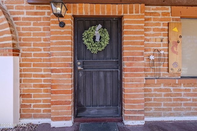 property entrance with brick siding