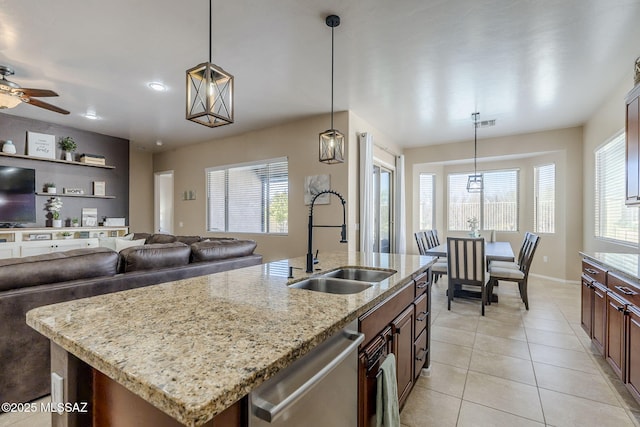 kitchen featuring pendant lighting, dishwasher, sink, a kitchen island with sink, and ceiling fan