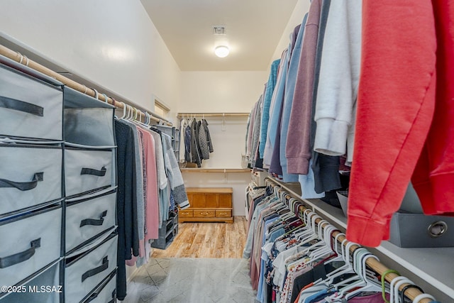 walk in closet featuring light hardwood / wood-style flooring