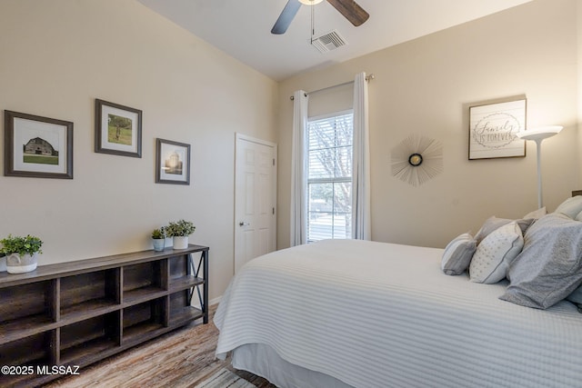 bedroom with ceiling fan and wood-type flooring