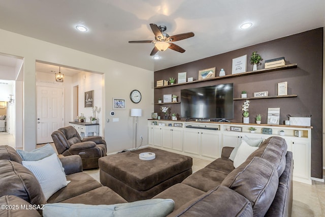 living room with ceiling fan with notable chandelier