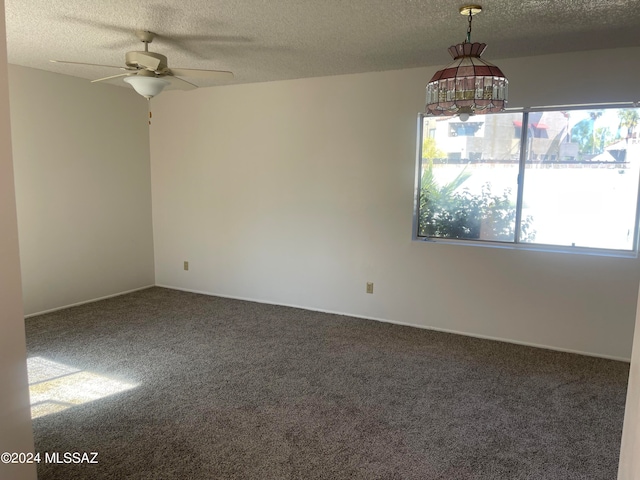 carpeted empty room with a textured ceiling and ceiling fan