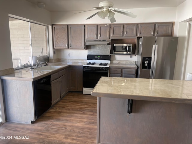 kitchen featuring sink, backsplash, dark hardwood / wood-style flooring, ceiling fan, and stainless steel appliances