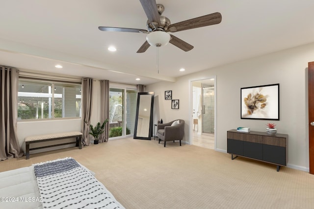 living area with light colored carpet and ceiling fan