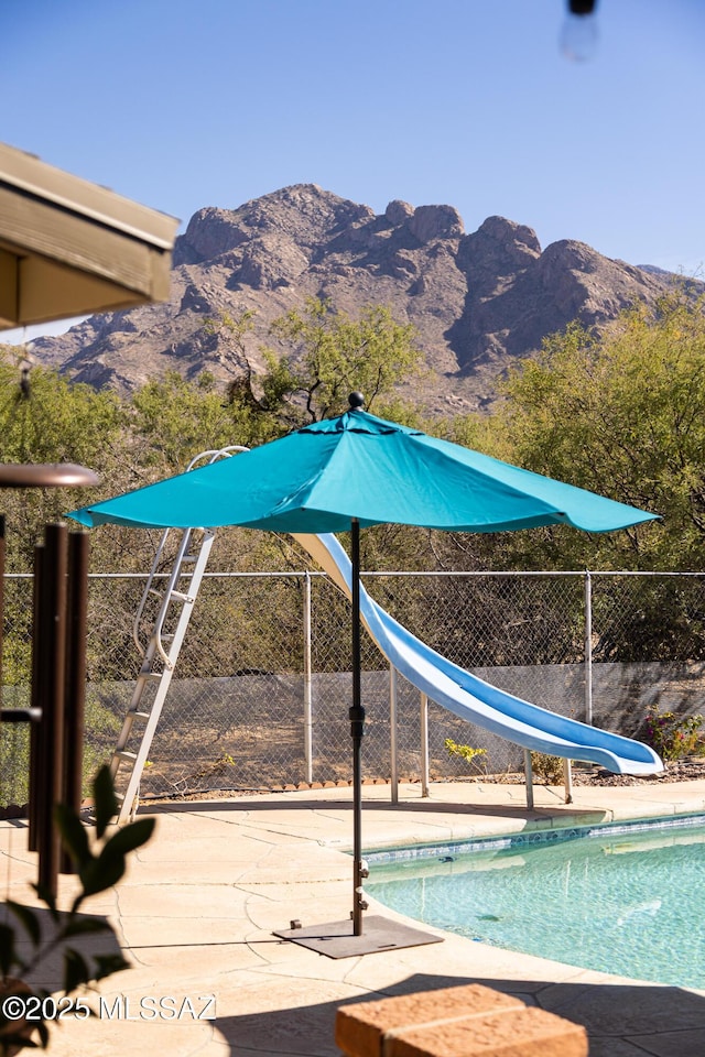 view of pool featuring a water slide and a mountain view