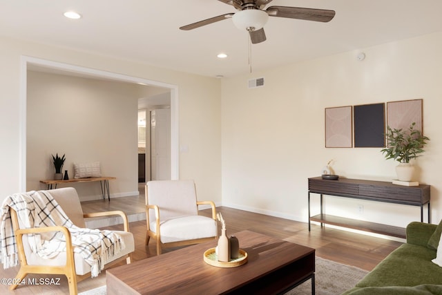 living room with ceiling fan and light hardwood / wood-style floors