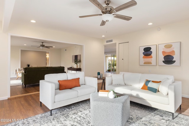 living room with ceiling fan and wood-type flooring