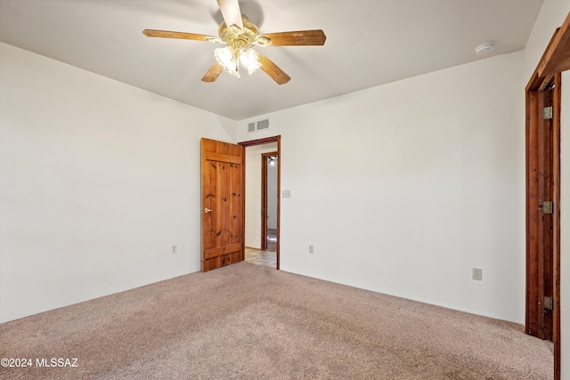 empty room with ceiling fan and carpet