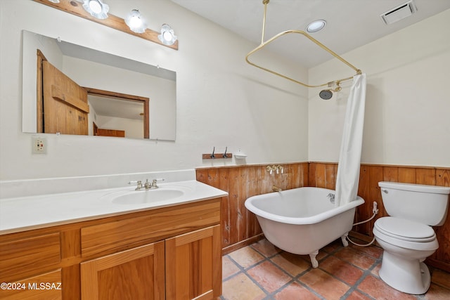 full bathroom featuring wood walls, shower / tub combo with curtain, vanity, and toilet