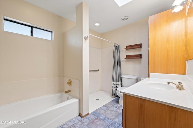 full bathroom featuring vanity, shower with separate bathtub, and toilet