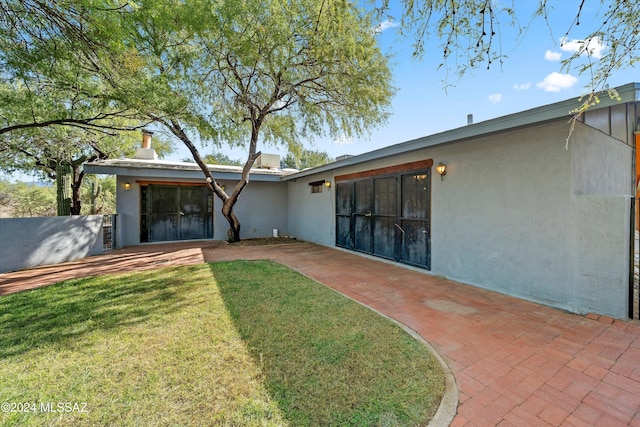 rear view of property with a yard